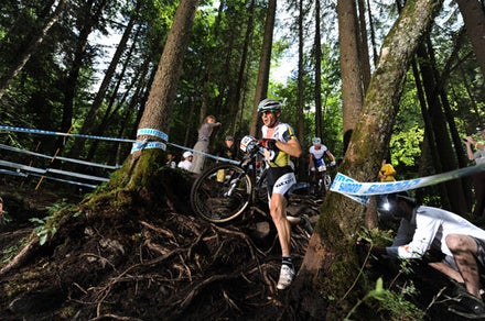 Florian Vogel dismounts his bike on the way to winning the Champery, Switzerland World Cup. Photo courtesy Bikepark.ch - Worldcup MTB 2010
