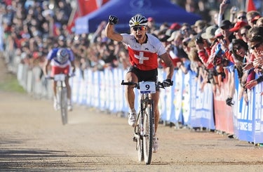 After a sprint finish in 2009, Nino Schurter celebrates his first MTB world championship victory. He pipped Julien Absalon, background. Photo by Frank Bodenmueller