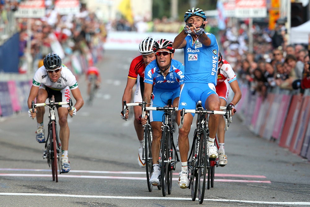 Italy's Olympic champion Paolo Bettini, left, looks at his