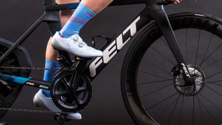 Close-up of women's cycling shoes on a Felt road bike