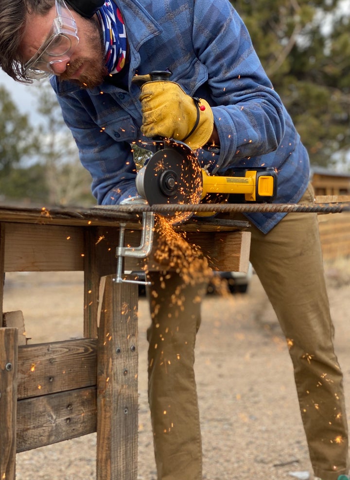 Alex Howes using a grinder to cut rebar