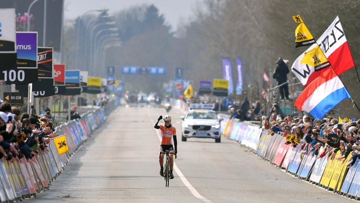 Anna Van Der Breggen celebrates crossing the line in a solo win