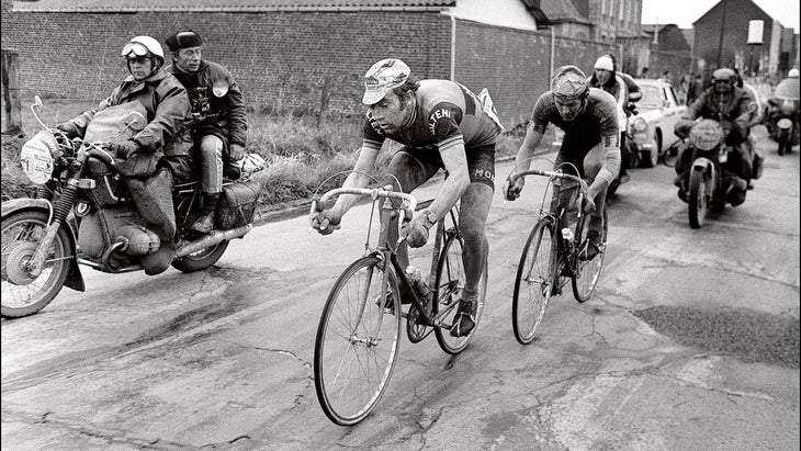 Merckx and De Vlaeminck ride surrounded by follow motorcycles