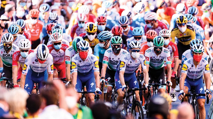 Large group of cyclists all with facemasks on