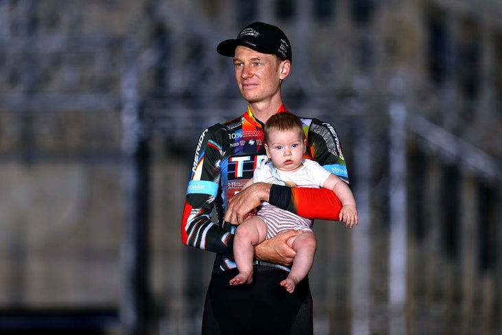 Jack Haig on the podium with his baby