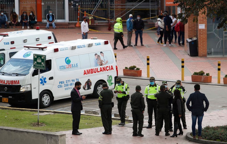 Police officers are seen at the main entrance of the 'Clinica Universitaria La Sabana', where former tour of france winner Egan Bernal is hospitalised, in Chia, north of Bogota, on January 24, 2022. - Former Tour de France winner Egan Bernal was "conscious" and "stable" in hospital following a training accident near his home town in Colombia, his cycling team Ineos Grenadiers said on Monday. (Photo by DANIEL MUNOZ / AFP) (Photo by DANIEL MUNOZ/AFP via Getty Images)