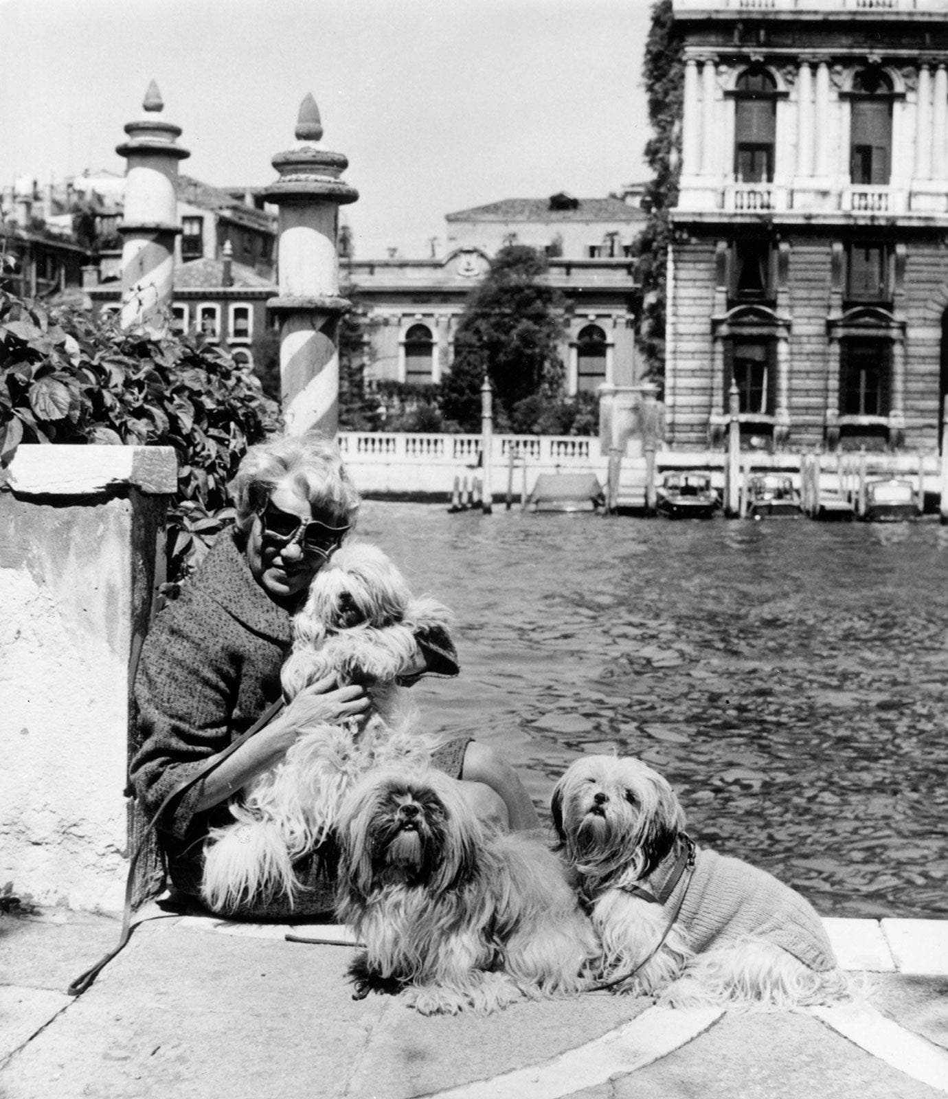 Peggy Guggenheim with her dogs in Venice, Italy.