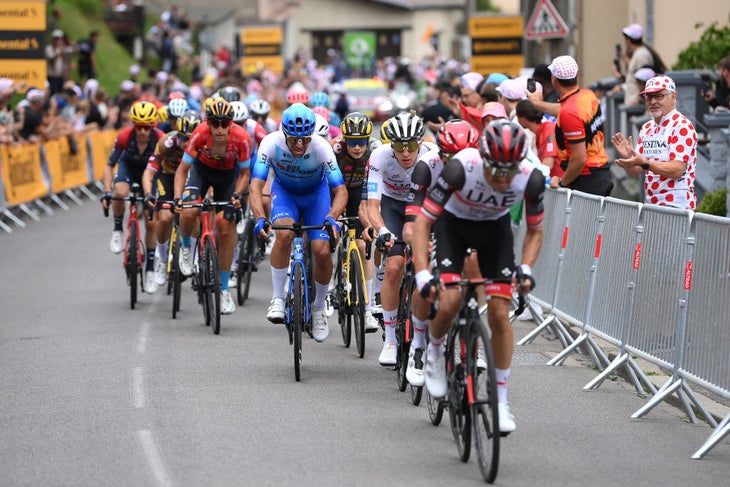 Michael Matthews sits just behind Tadej Pogacar on the final climb