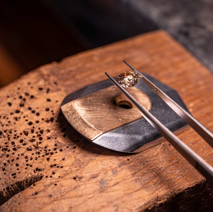 A 2-carat diamond being placed into the headset cap of a Colnago Gioiello road bike.