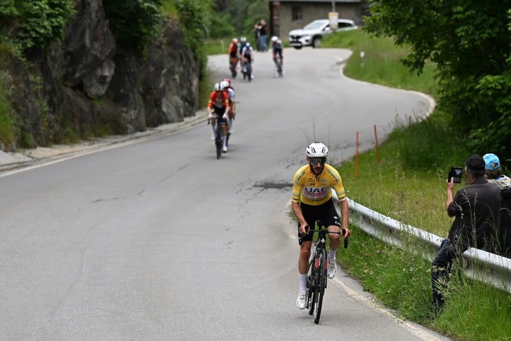 Adam Yates of The United Kingdom and UAE Team Emirates - Yellow leader jersey competes during the 87th Tour de Suisse 2024, Stage 6 a 42.5km stage from Ulrichen to Blatten 1330m / #UCIWT / on June 14, 2024 in Blatten, Switzerland. (Photo by Tim de Waele/Getty Images)