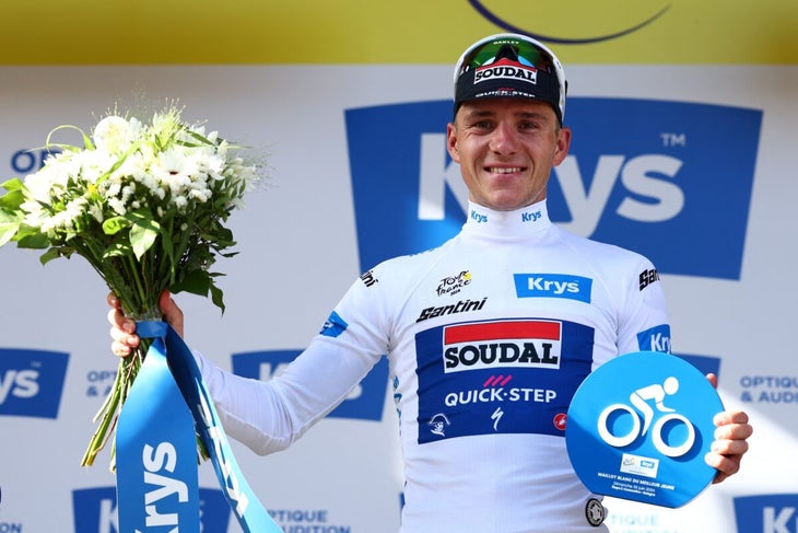 Belgian Remco Evenepoel of Soudal Quick-Step celebrates on the podium in the white jersey for best young rider after stage 2 of the 2024 Tour de France cycling race, from Cesenatico, Italy to Bologna, Italy (198,7km) on Sunday 30 June 2024. The 111th edition of the Tour de France starts on Saturday 29 June and will finish in Nice, France on 21 July. BELGA PHOTO DAVID PINTENS (Photo by DAVID PINTENS / BELGA MAG / Belga via AFP)