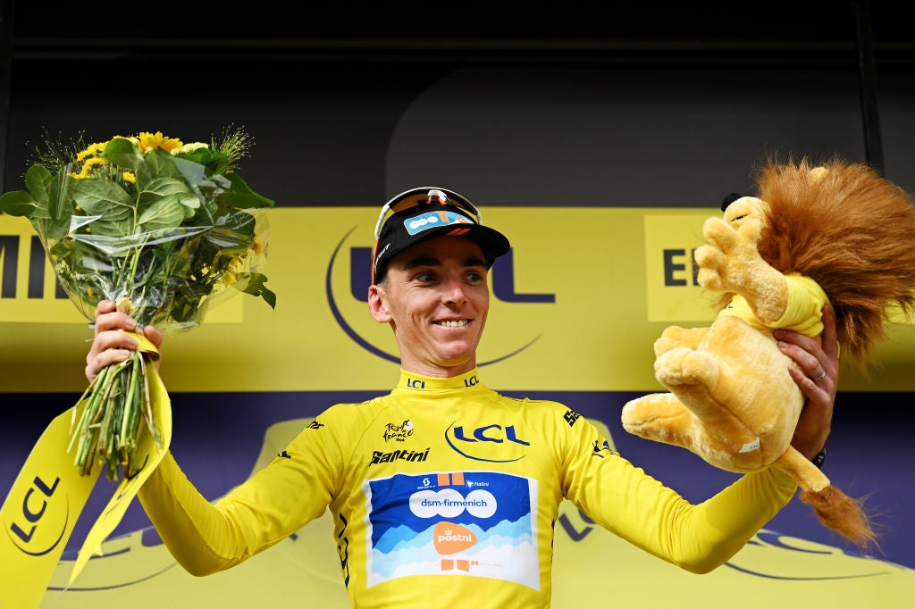 RIMINI, ITALY - JUNE 29: Romain Bardet of France and Team dsm-firmenich PostNL celebrates at podium as Yellow Leader Jersey winner with the TDF Lion Mascot during the 111th Tour de France 2024, Stage 1 a 206km stage from Firenze to Rimini / #UCIWT / on June 29, 2024 in Rimini, Italy. (Photo by Dario Belingheri/Getty Images)