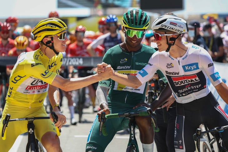 Remco Evenepoel on Looming World Champs Battle: ‘It Won't Be Easy' 2 UAE Team Emirates team's Slovenian rider Tadej Pogacar wearing the overall leader's yellow jersey shakes hands with Soudal Quick-Step team's Belgian rider Remco Evenepoel wearing the best young rider's white jersey (R) as Intermarche - Wanty team's Eritrean rider Biniam Girmay wearing the sprinter's green jersey (C) looks at the start of the 20th stage of the 111th edition of the Tour de France cycling race, 132,8 km between Nice and Col de la Couillole, southeastern France, on July 20, 2024. (Photo by Anne-Christine POUJOULAT / AFP)