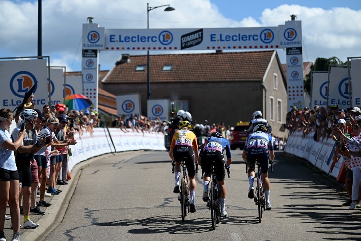 AMNEVILLE, FRANCE - AUGUST 15: (L-R) Fem Van Empel of The Netherlands and Team Visma | Lease a Bike, Loes Adegeest of The Netherlands and Team FDJ - SUEZ and Julie Van De Velde of Belgium and AG Insurance - Soudal Team compete in the breakaway while fans cheer during the 3rd Tour de France Femmes 2024, Stage 5 a 152.2km stage from Bastogne to Amneville / #UCIWWT / on August 15, 2024 in Amneville, France. (Photo by Dario Belingheri/Getty Images)