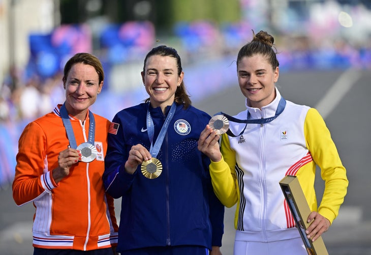 L-R, silver medalist Dutch Marianne Vos, gold medalist winner US Kristen Faulkner and Bronze medalist Belgian Lotte Kopecky celebrate on the podium with their medals after the women's road race at the Paris 2024 Olympic Games, on Sunday 04 August 2024 in Paris, France. The Games of the XXXIII Olympiad are taking place in Paris from 26 July to 11 August. The Belgian delegation counts 165 athletes competing in 21 sports. BELGA PHOTO DIRK WAEM (Photo by DIRK WAEM / BELGA MAG / Belga via AFP)