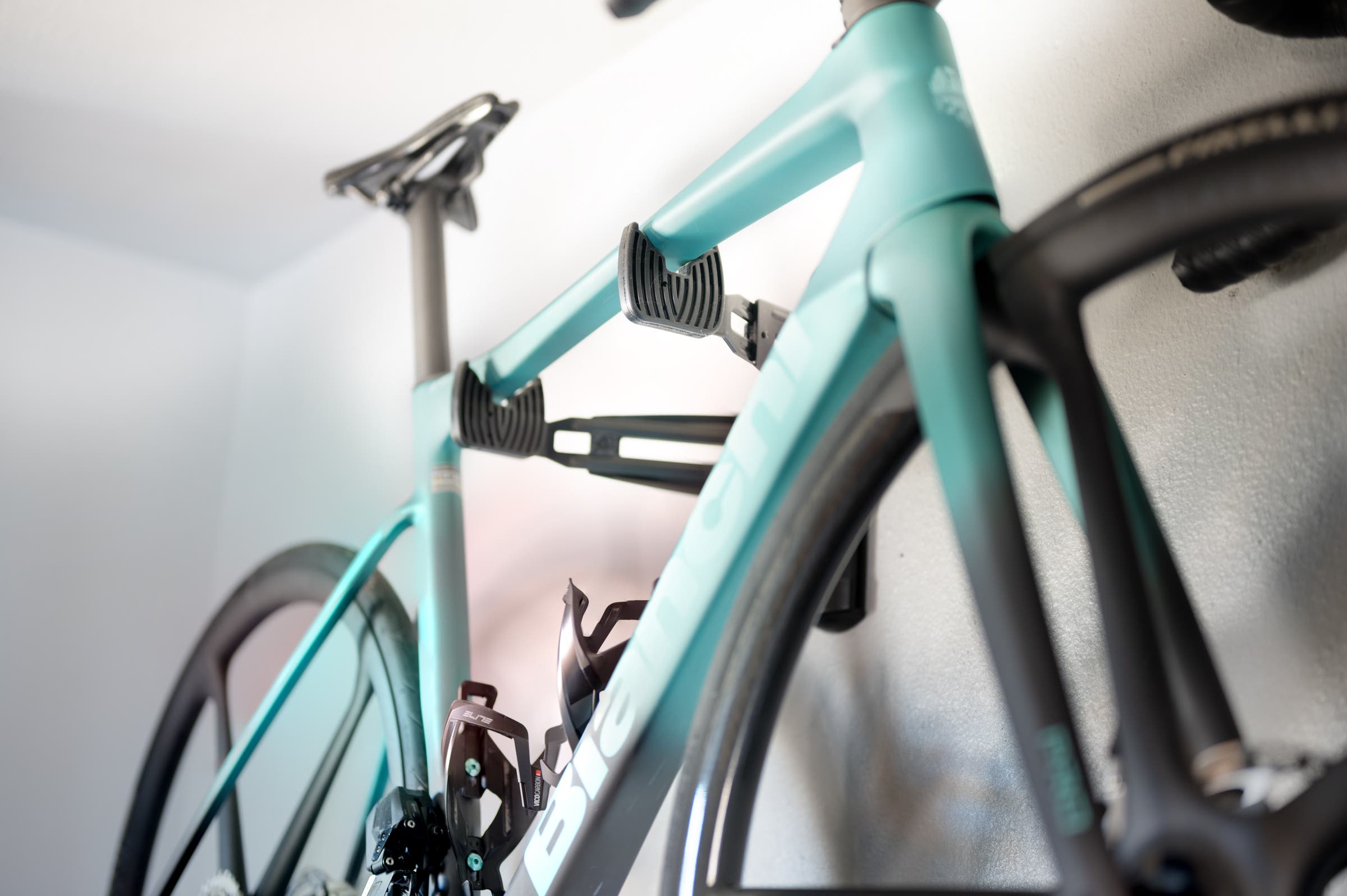 bianchi specialissima sitting on a Feedback Sports Velo Wall Rack 2D