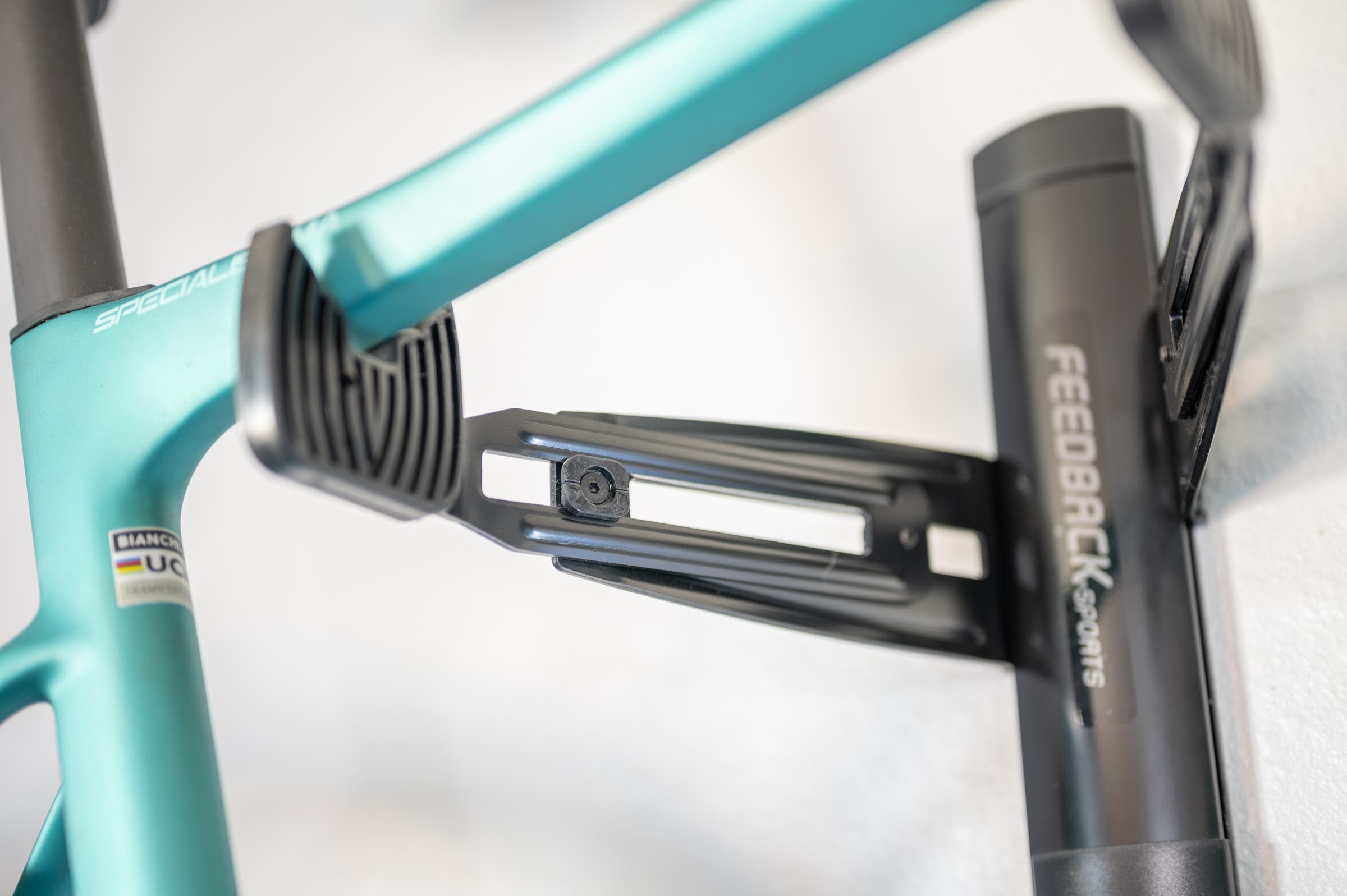 bianchi specialissima sitting on a Feedback Sports Velo Wall Rack 2D