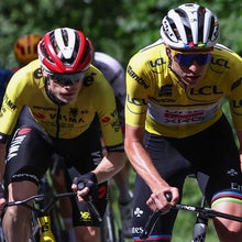 Team Visma - Lease a Bike's Danish rider Jonas Vingegaard (Centre L) and UAE Team Emirates XRG's Slovenian rider Tadej Pogačar wearing the overall leader's yellow jersey cycle during the 7th stage of the 77th edition of the Criterium du Dauphine cycling race, 131,6 km between Grand-Aigueblanche and Valmeinier, on June 14, 2025. (Photo by Anne-Christine POUJOULAT / AFP)