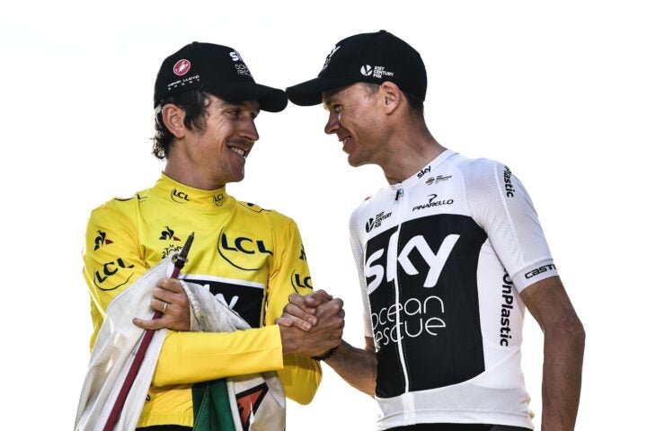 TOPSHOT - Tour de France 2018 winner Great Britain's Geraint Thomas (L), wearing the overall leader's yellow jersey, shakes hands with third-placed Great Britain's Christopher Froome on the podium after the 21st and last stage of the 105th edition of the Tour de France cycling race between Houilles and Paris Champs-Elysees, on July 29, 2018. (Photo by Jeff PACHOUD / AFP) (Photo credit should read JEFF PACHOUD/AFP via Getty Images)