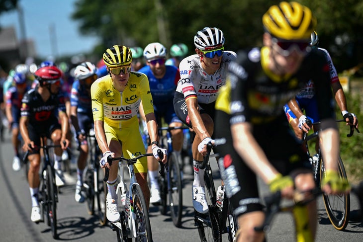 UAE Team Emirates - XRG team's Slovenian rider Tadej Pogacar wearing the overall leader's yellow jersey (C) and UAE Team Emirates - XRG team's German rider Nils Politt (2nd R) cycle during the 8th stage of the 112th edition of the Tour de France cycling race, 171.4 km between Saint-Meen-le-Grand and Laval Espace Mayenne, western France, on July 12, 2025. (Photo by Loic VENANCE / AFP)