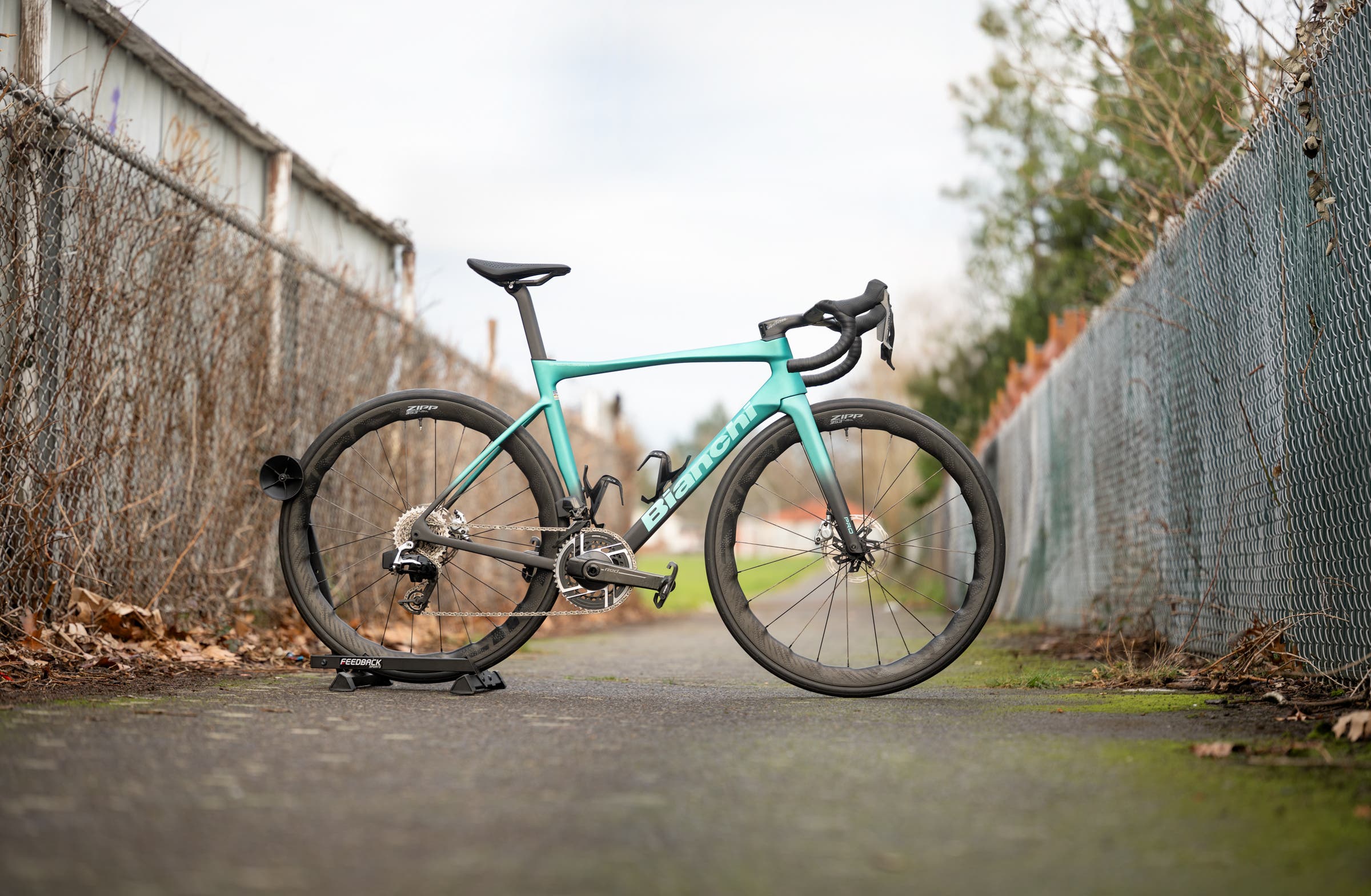 Side profile of a bianchi specialissima pro in signature Celeste green, featuring a wireless SRAM Red AXS 12-speed groupset, and SRAM 353 NSW wheels
