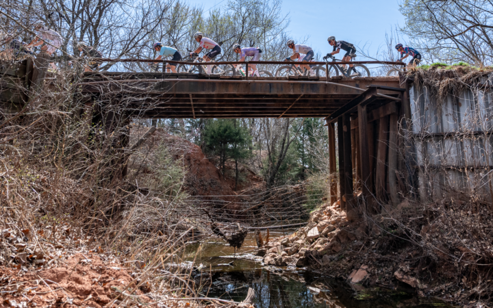 Cyclists riding over one of many old bridges along the course in central Oklahoma.