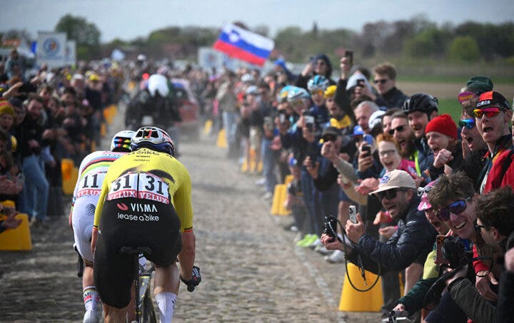 UAE Team Emirates XRG's Slovenian rider Tadej Pogacar (L) and Team Visma - Lease a Bike's Belgian rider Wout van Aert cycle in a breakaway on a cobblestone sector during the 123rd edition of the Paris-Roubaix one-day classic cycling race, 258.3 km between Compiègne and Roubaix, northern France, on April 12, 2026. (Photo by Etienne GARNIER / POOL / AFP via Getty Images)