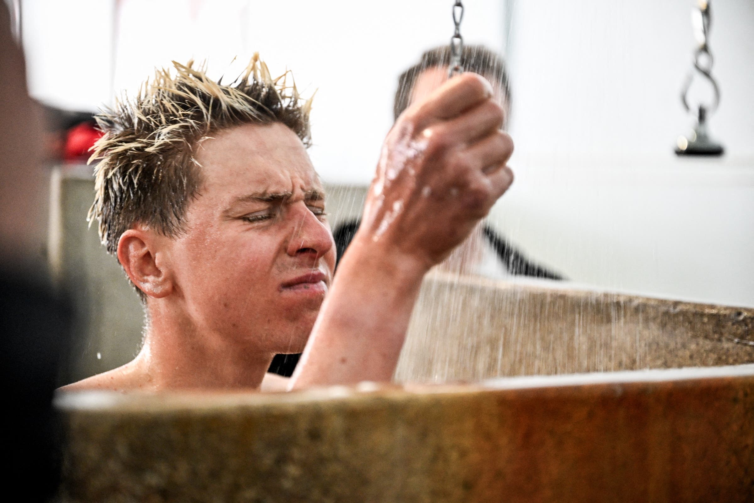 Slovenian Tadej Pogacar washes away the dust and disappointment after Paris-Roubaix 2026 (Photo: Jasper Jacobs / Belga Mag via AFP)