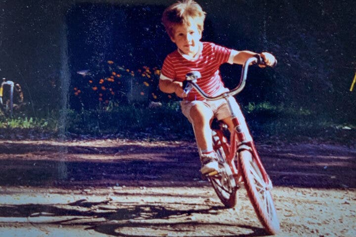 Family photo of Brian on a bike.