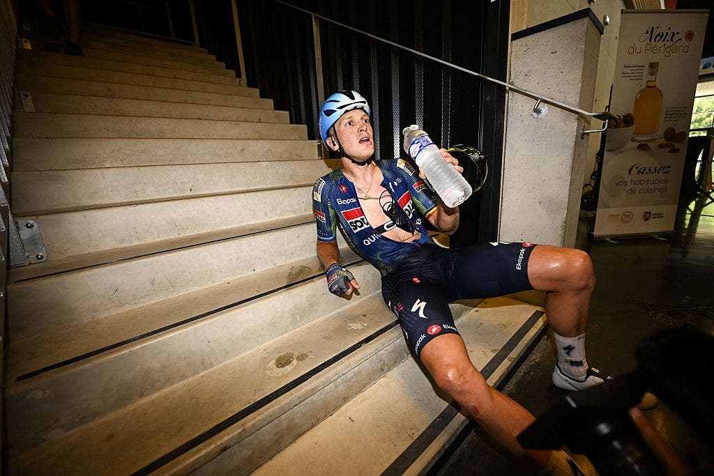 Tim Merlier collapsed into a sweaty pile after he won stage 8 of the Tour de France