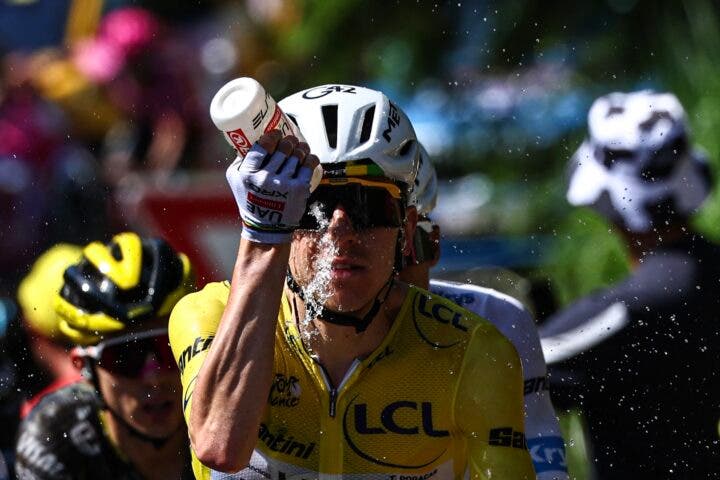 UAE Team Emirates - XRG's Slovenian rider Tadej Pogacar wearing the overall leader's yellow jersey douses himself with water to cool down during the 9th stage of the 113th edition of the Tour de France cycling race, 154,6 km between Malemort and Ussel in central France, on July 12, 2026. (Photo: Anne-Christine Poujoulat / AFP)