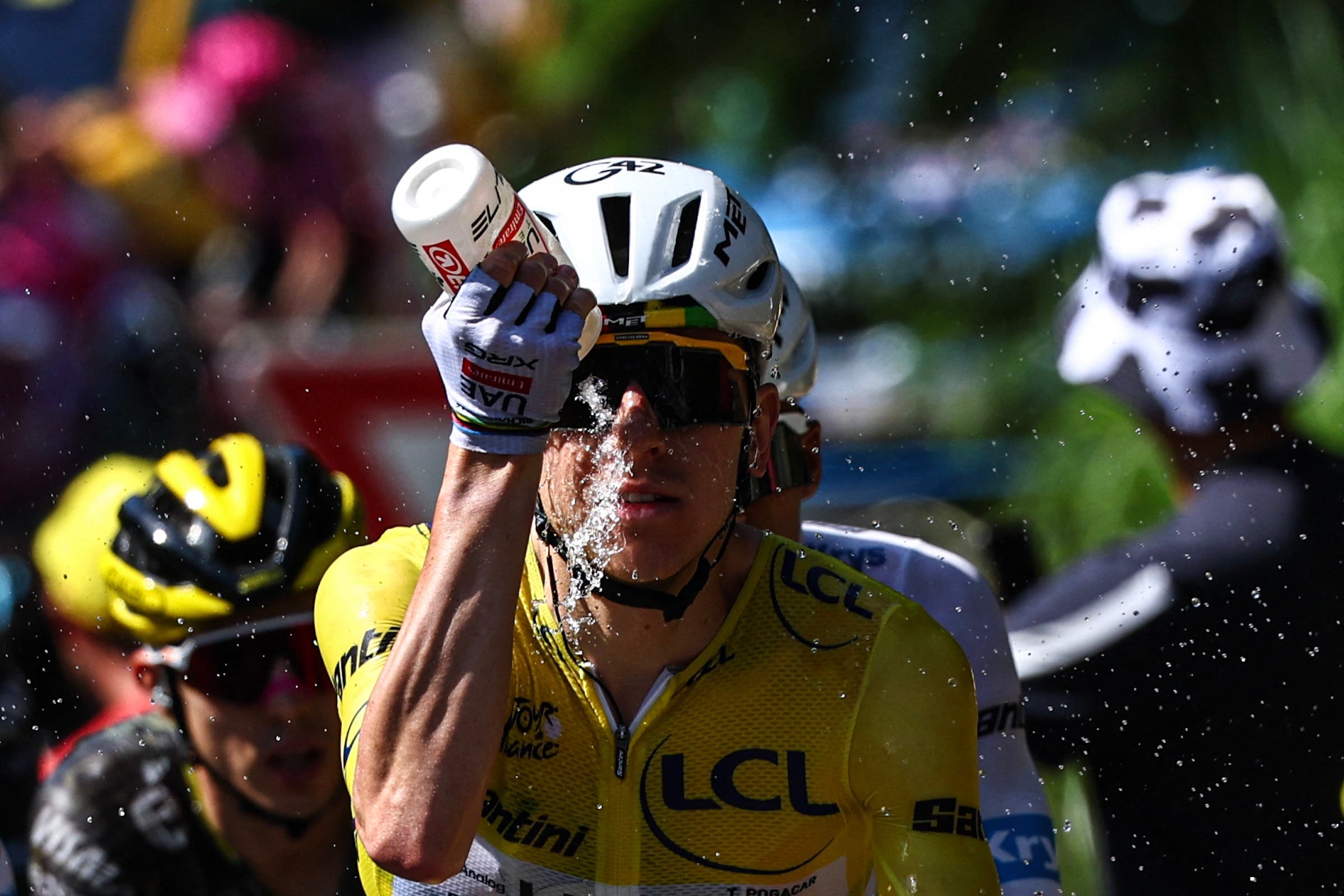 UAE Team Emirates - XRG's Slovenian rider Tadej Pogacar wearing the overall leader's yellow jersey douses himself with water to cool down during the 9th stage of the 113th edition of the Tour de France cycling race, 154,6 km between Malemort and Ussel in central France, on July 12, 2026. (Photo: Anne-Christine Poujoulat / AFP)